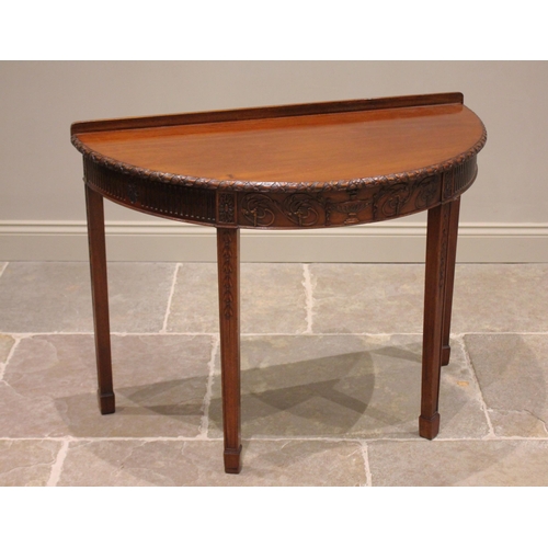 777 - A mahogany demi lune hall table, in the Adam style, early 20th century, the bow front top with ribbo... 