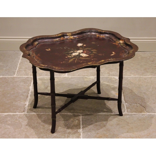 785 - A Victorian papier mache tray top table, the shaped tray centred with a painted spray of blooms, enc... 