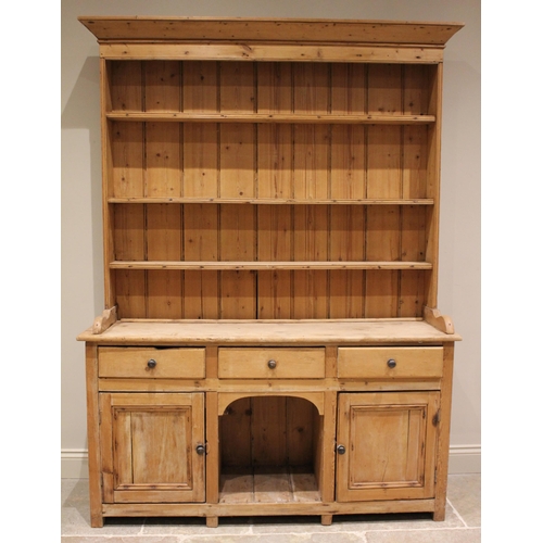 796 - A 19th century pine dresser, the enclosed plate rack with a moulded cornice over three shelves, upon... 