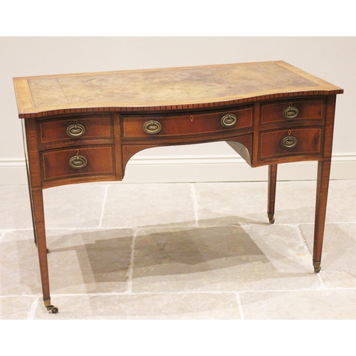 807 - An Edwardian mahogany serpentine writing desk, in the manner of Maple & Co, the leather skiver inset... 