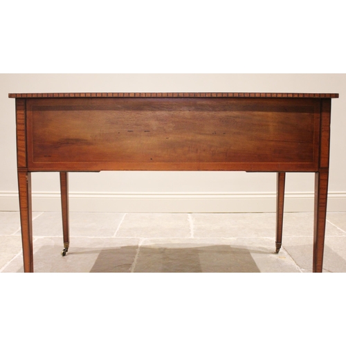 807 - An Edwardian mahogany serpentine writing desk, in the manner of Maple & Co, the leather skiver inset... 