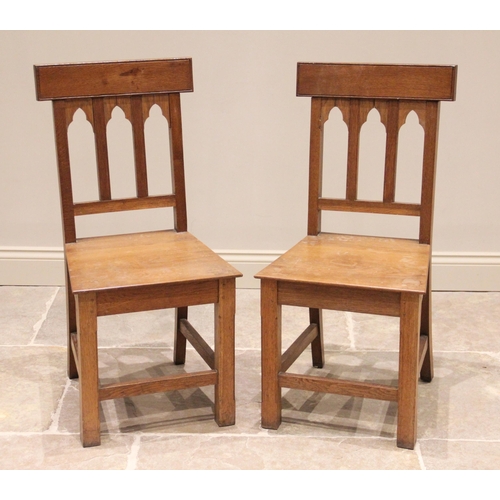 813 - A pair of honey oak altar/hall chairs, 20th century, each  with a rail back over a board seat, raise... 