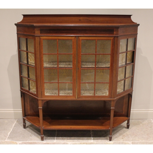 815 - An Edwardian mahogany and satinwood crossbanded display cabinet, of angular bowfront form, with a ga... 