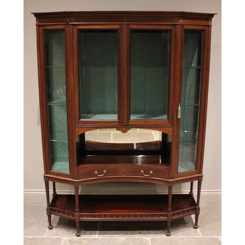 816 - An Edwardian mahogany display cabinet, of canted form, the frieze inlaid with roundel detail above a... 