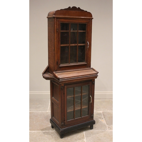 817 - An early 20th century glazed oak freestanding clerks cabinet, the shaped pediment above a glazed doo... 