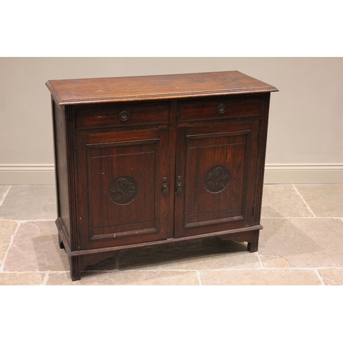 819 - An early 20th century oak Arts and Crafts side cabinet, the rectangular moulded top above two frieze... 