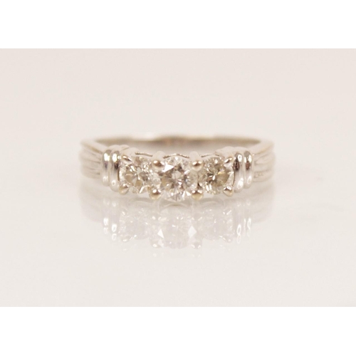 82 - A diamond three-stone 14ct gold ring, the central round brilliant cut diamond weighing approximately... 