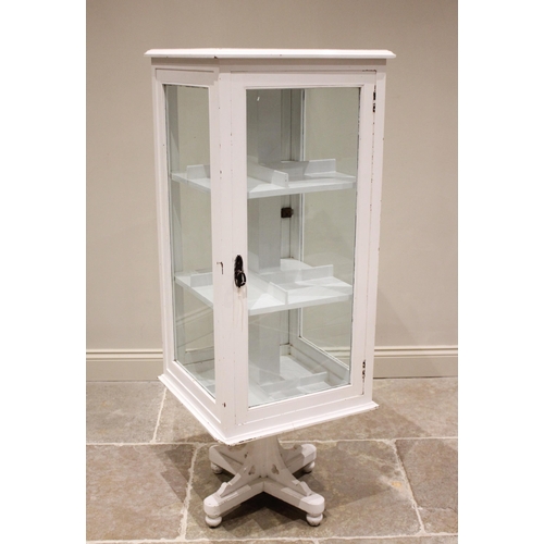 827 - An early 20th century painted wooden revolving display/library bookcase, the single glazed door open... 