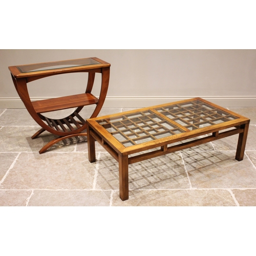 839 - A contemporary elm and glass top coffee table, the rectangular top with a pair of inset glass panels... 