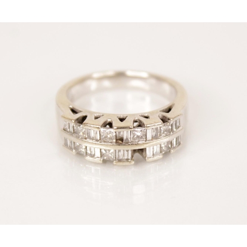 84 - A diamond set 14ct gold ring, comprising two rows of princess cut and baguette cut diamonds, channel... 