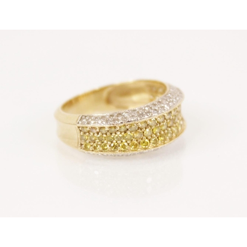 85 - A white and yellow diamond 14ct gold ring, the central recessed pave set with three rows of coloured... 