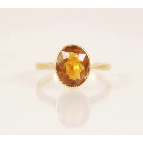 158 - An early 20th century 18ct gold yellow gemstone set dress ring, the central oval mixed cut yellow ge... 