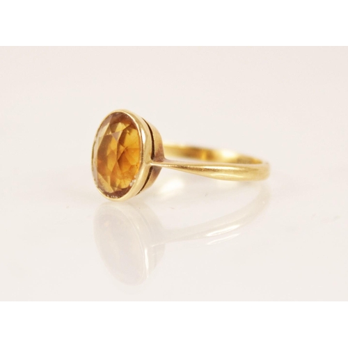 158 - An early 20th century 18ct gold yellow gemstone set dress ring, the central oval mixed cut yellow ge... 