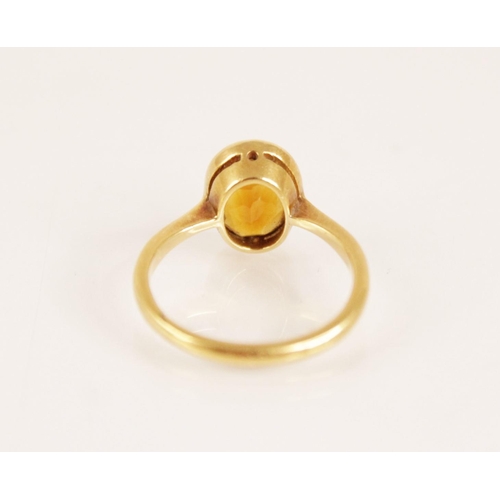 158 - An early 20th century 18ct gold yellow gemstone set dress ring, the central oval mixed cut yellow ge... 