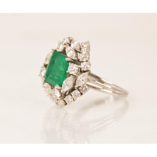 159 - An emerald and diamond ring, the central rectangular step cut emerald measuring 9.7mm x 8.0mm, set t... 