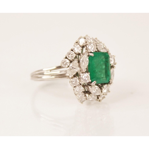 159 - An emerald and diamond ring, the central rectangular step cut emerald measuring 9.7mm x 8.0mm, set t... 