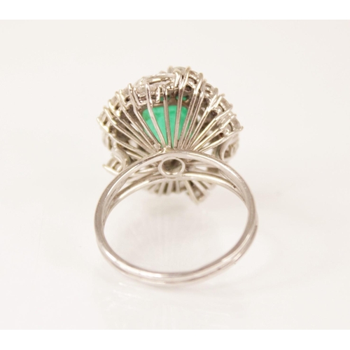 159 - An emerald and diamond ring, the central rectangular step cut emerald measuring 9.7mm x 8.0mm, set t... 