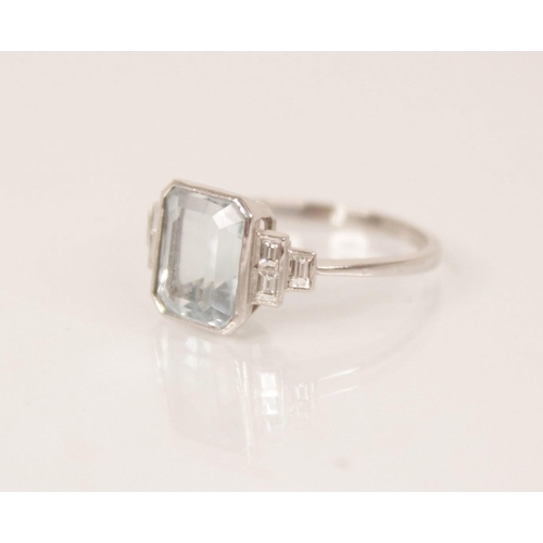 162 - An Art Deco aquamarine and diamond ring, the central emerald cut aquamarine measuring 9.5mm x 7.6mm ... 