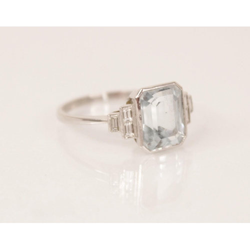 162 - An Art Deco aquamarine and diamond ring, the central emerald cut aquamarine measuring 9.5mm x 7.6mm ... 