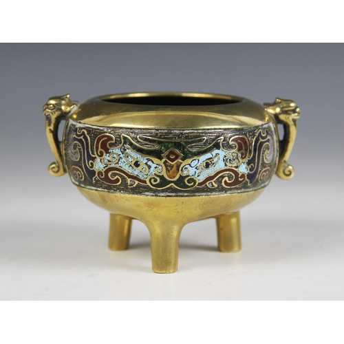 425 - A Chinese bronze champlevé enamel tripod censer, the polished bronzed body of compressed form flanke... 