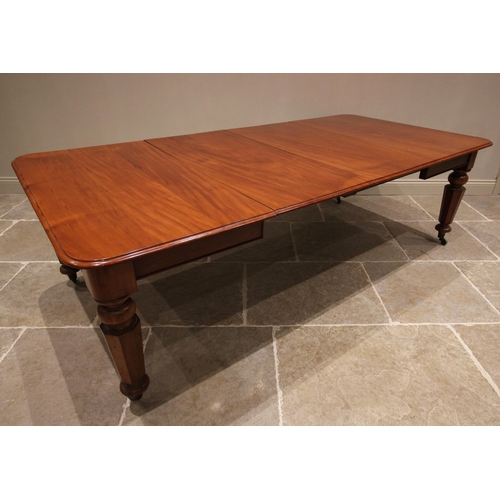 802 - A Victorian mahogany extending dining table, the rectangular moulded top with rounded corners above ... 