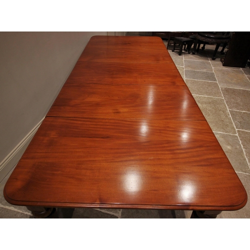 802 - A Victorian mahogany extending dining table, the rectangular moulded top with rounded corners above ... 