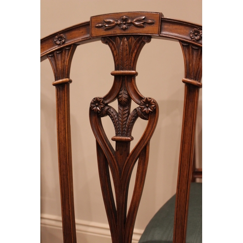 832 - A set of four walnut Hepplewhite style dining chairs, late 19th/early 20th century, the arched rail ... 