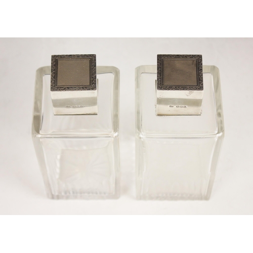 32 - A pair of Art Deco cut glass silver mounted scent bottles, each colourless glass body of rectangular... 