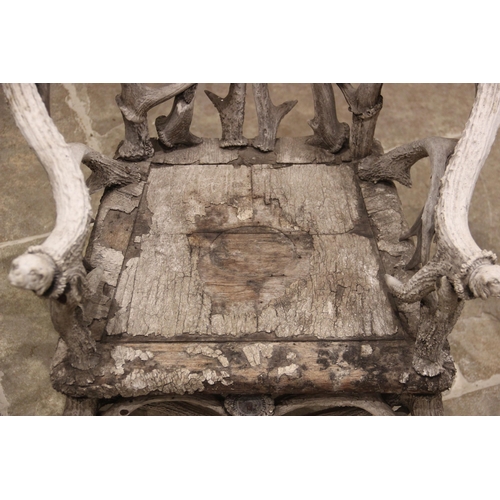 788 - A pair of 19th century red and fallow deer antler chairs, the oak seats overlaid with antler bark ra... 