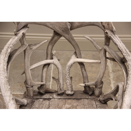 788 - A pair of 19th century red and fallow deer antler chairs, the oak seats overlaid with antler bark ra... 