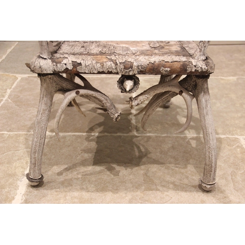 788 - A pair of 19th century red and fallow deer antler chairs, the oak seats overlaid with antler bark ra... 