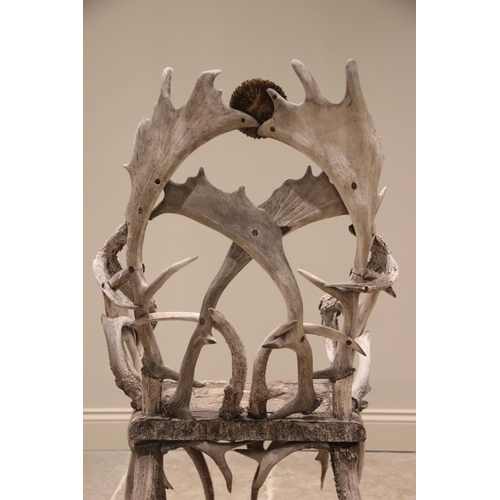 788 - A pair of 19th century red and fallow deer antler chairs, the oak seats overlaid with antler bark ra... 