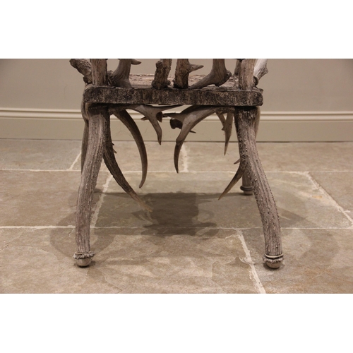 788 - A pair of 19th century red and fallow deer antler chairs, the oak seats overlaid with antler bark ra... 