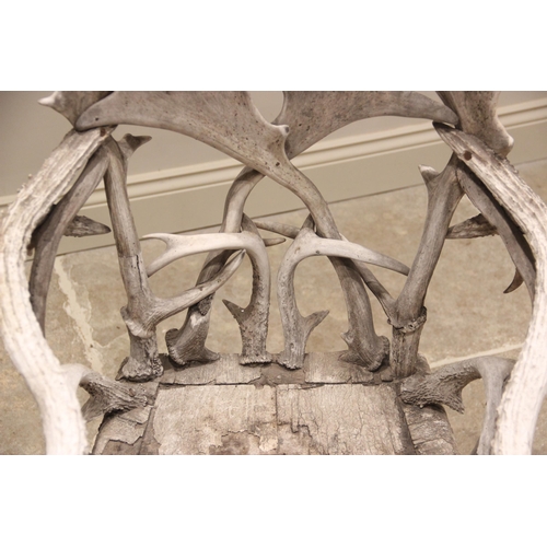 788 - A pair of 19th century red and fallow deer antler chairs, the oak seats overlaid with antler bark ra... 