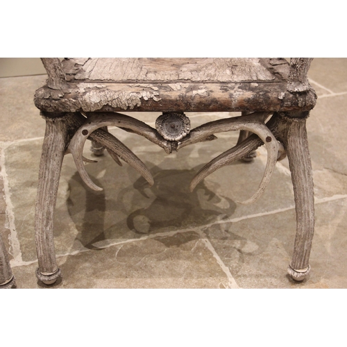 788 - A pair of 19th century red and fallow deer antler chairs, the oak seats overlaid with antler bark ra... 