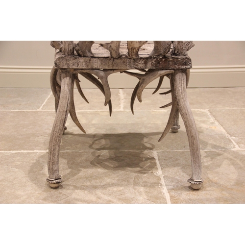 788 - A pair of 19th century red and fallow deer antler chairs, the oak seats overlaid with antler bark ra... 