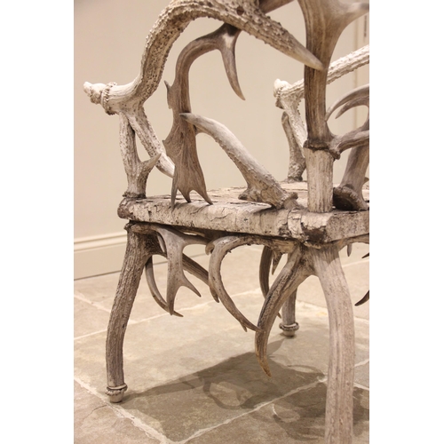 788 - A pair of 19th century red and fallow deer antler chairs, the oak seats overlaid with antler bark ra... 