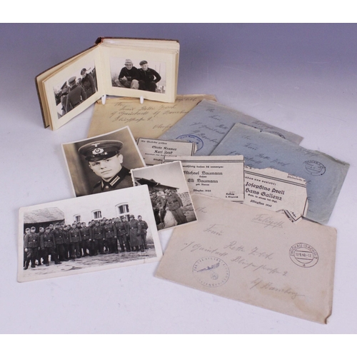 193 - WORLD WAR II INTEREST: A WWII German photograph album containing thirty seven 6cm x 9cm monochrome p... 