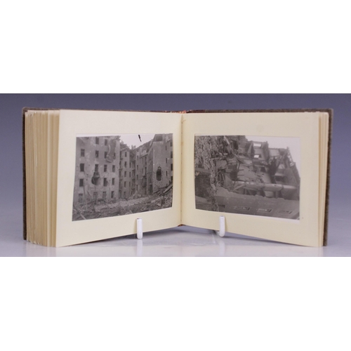 193 - WORLD WAR II INTEREST: A WWII German photograph album containing thirty seven 6cm x 9cm monochrome p... 