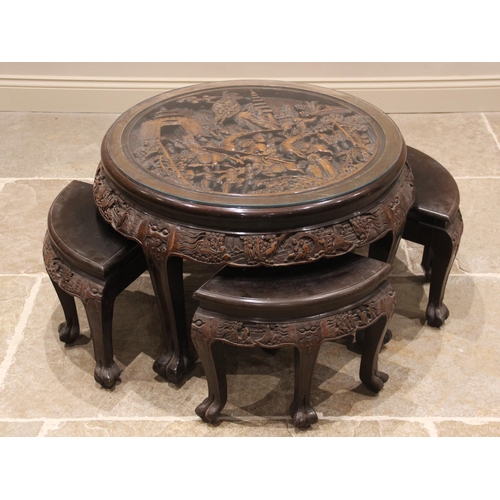 387 - A Chinese relief carved circular occasional table with integral nest of four tables, the table top d... 