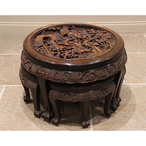 387 - A Chinese relief carved circular occasional table with integral nest of four tables, the table top d... 