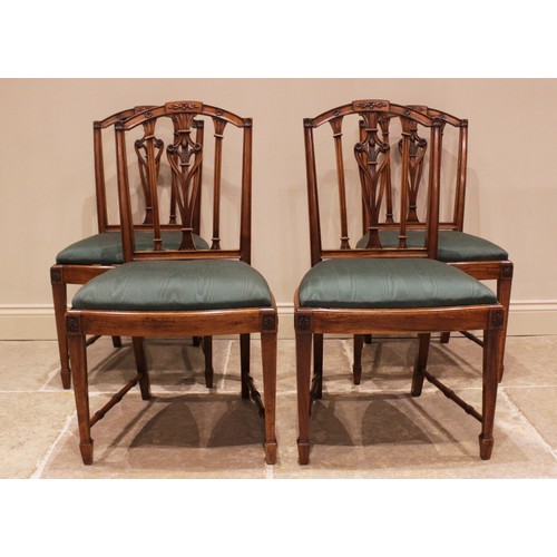 832 - A set of four walnut Hepplewhite style dining chairs, late 19th/early 20th century, the arched rail ... 