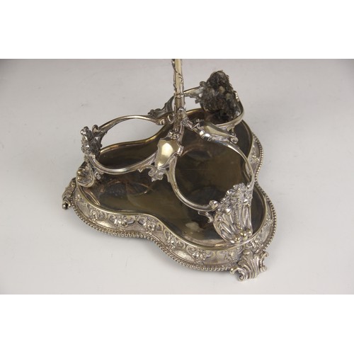 28 - A Victorian three bottle decanter stand, late 19th century, the trefoil base raised on scroll and ac... 