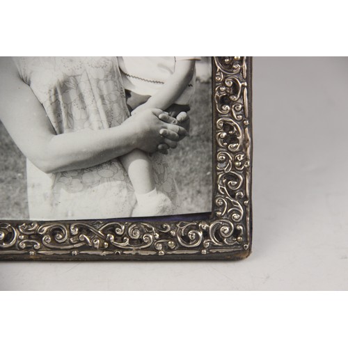 43 - A Victorian silver mounted photograph frame, Henry Matthews, Birmingham 1899, of rectangular form, e... 