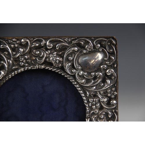 44 - An Edwardian silver mounted photograph frame, W J Myatt & Co, Birmingham 1903, of square form emboss... 