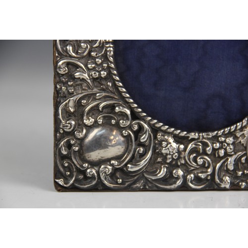 44 - An Edwardian silver mounted photograph frame, W J Myatt & Co, Birmingham 1903, of square form emboss... 