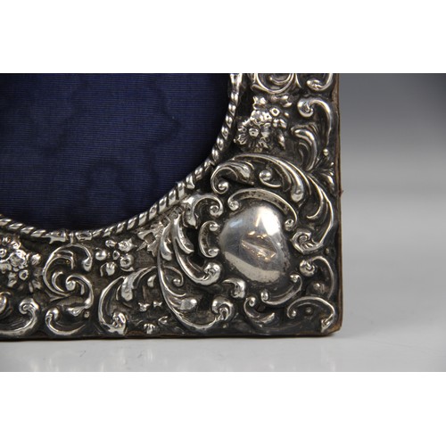 44 - An Edwardian silver mounted photograph frame, W J Myatt & Co, Birmingham 1903, of square form emboss... 