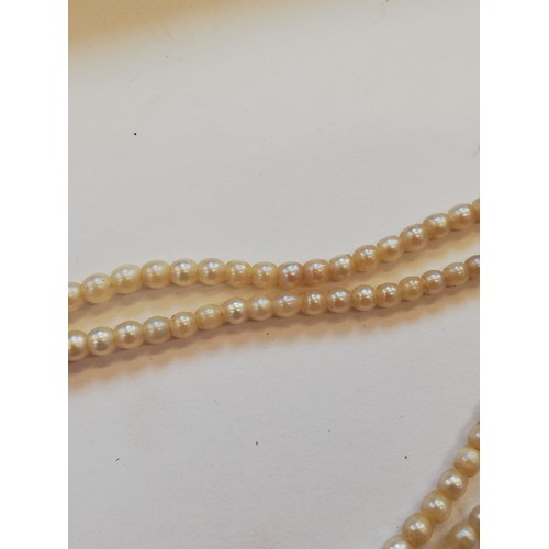 129 - A cultured pearl choker with diamond set clasp, comprising two rows of off-round cultured pearls, me... 