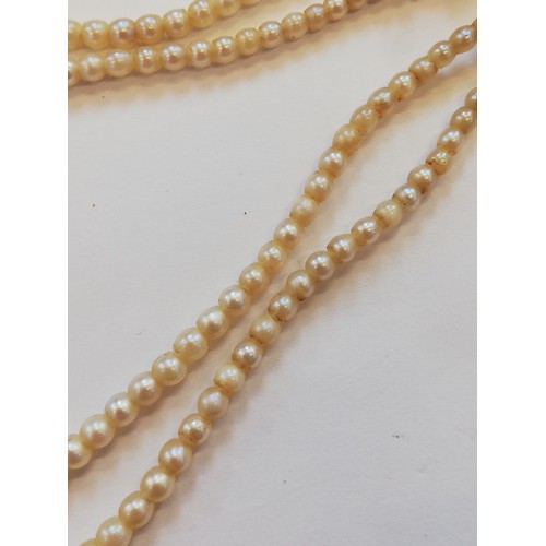 129 - A cultured pearl choker with diamond set clasp, comprising two rows of off-round cultured pearls, me... 