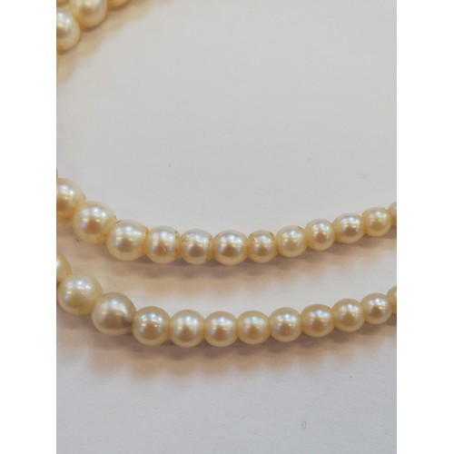 129 - A cultured pearl choker with diamond set clasp, comprising two rows of off-round cultured pearls, me... 